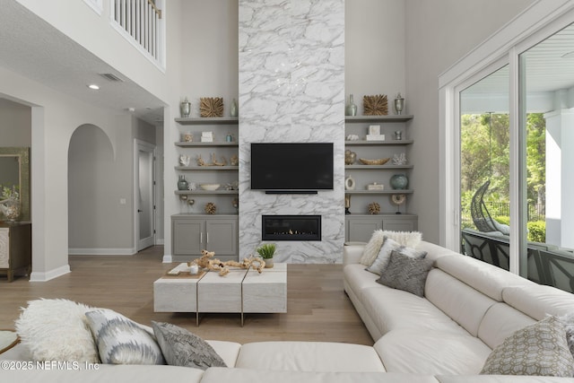 247 Vale Dr, Saint Augustine, FL 32095 - living area with wood finished floors, visible vents, arched walkways, baseboards, and a fireplace