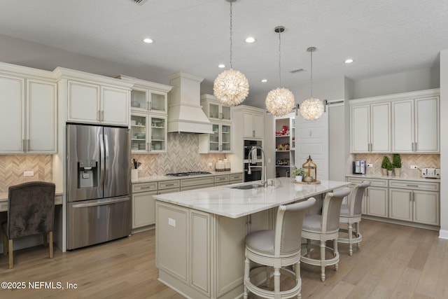 247 Vale Dr, Saint Augustine, FL 32095 - kitchen with recessed lighting, decorative backsplash, appliances with stainless steel finishes, custom exhaust hood, and a notable chandelier