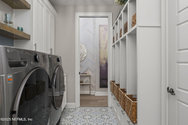 247 Vale Dr, Saint Augustine, FL 32095 - washroom with washing machine and clothes dryer, baseboards, light tile patterned floors, and cabinet space