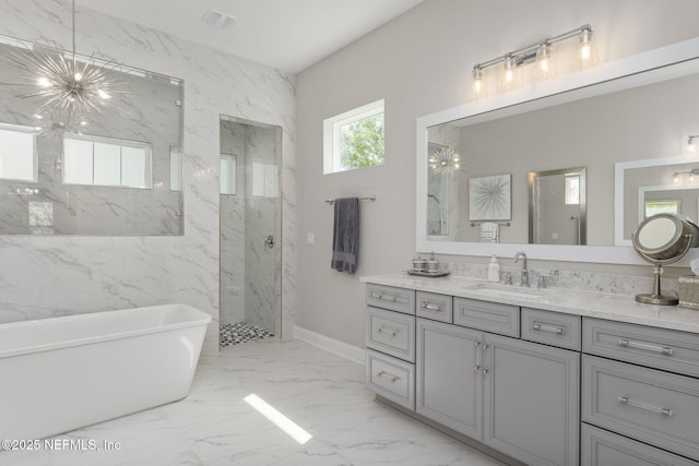 247 Vale Dr, Saint Augustine, FL 32095 - full bathroom with a soaking tub, a marble finish shower, baseboards, marble finish floor, and vanity