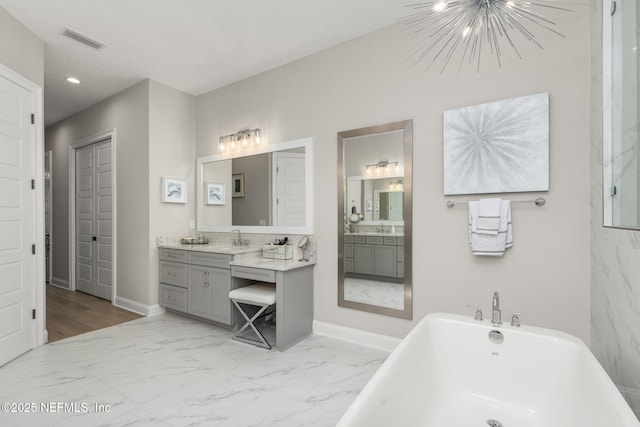 247 Vale Dr, Saint Augustine, FL 32095 - bathroom featuring marble finish floor, a soaking tub, a sink, and visible vents