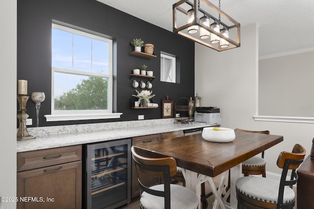 247 Vale Dr, Saint Augustine, FL 32095 - bar with beverage cooler, a textured ceiling, ornamental molding, and bar area