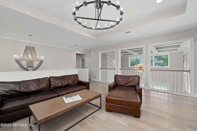 247 Vale Dr, Saint Augustine, FL 32095 - living area with light wood finished floors, a tray ceiling, a chandelier, and visible vents