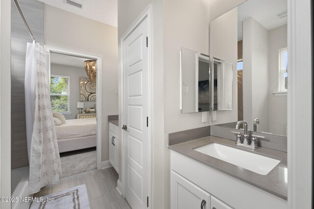 247 Vale Dr, Saint Augustine, FL 32095 - bathroom featuring baseboards, vanity, ensuite bathroom, and visible vents