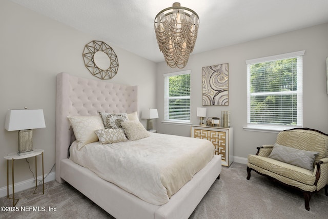 247 Vale Dr, Saint Augustine, FL 32095 - carpeted bedroom with baseboards and a chandelier