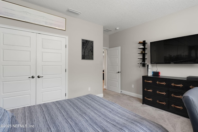 247 Vale Dr, Saint Augustine, FL 32095 - bedroom with a textured ceiling, baseboards, visible vents, light colored carpet, and a closet