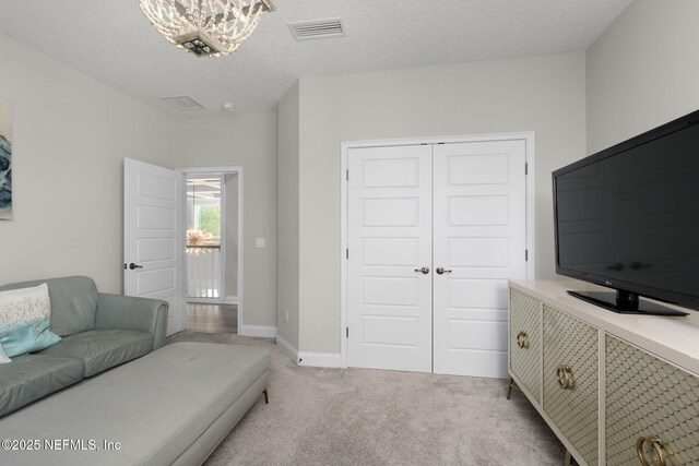 247 Vale Dr, Saint Augustine, FL 32095 - living area featuring baseboards, visible vents, an inviting chandelier, and light colored carpet
