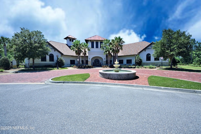 247 Vale Dr, Saint Augustine, FL 32095 - mediterranean / spanish house with stucco siding, a tile roof, and curved driveway