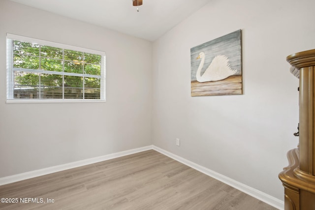 empty room featuring light wood-type flooring, baseboards, and ceiling fan