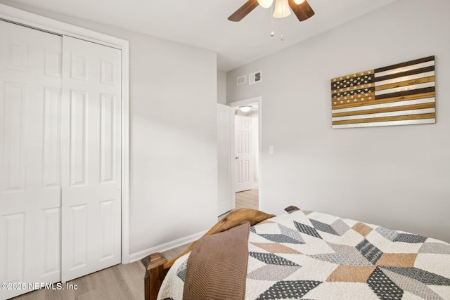 bedroom featuring light wood-style floors, ceiling fan, baseboards, and visible vents