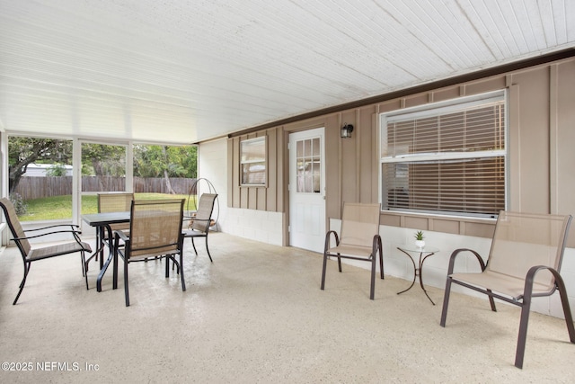 sunroom / solarium with speckled floor
