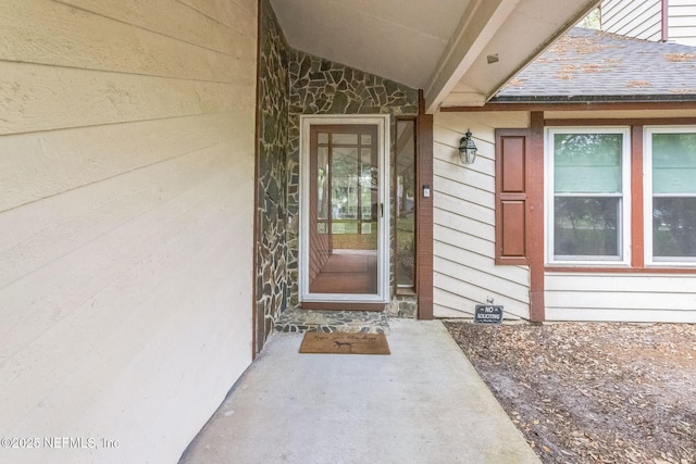 doorway to property with stone siding