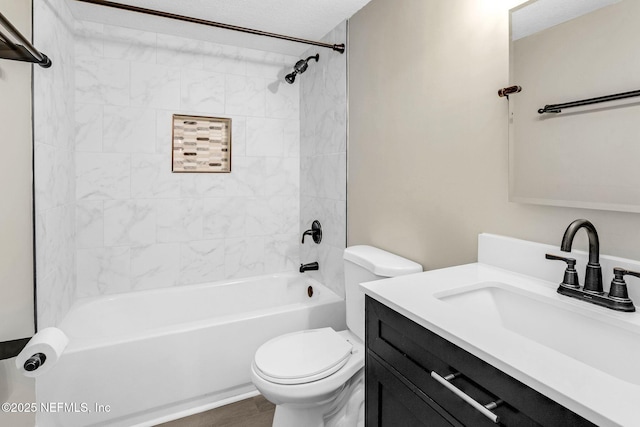 bathroom with toilet, vanity, and tub / shower combination