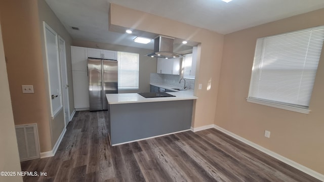 2756 Hidden Village Dr, Jacksonville, FL 32216 - kitchen featuring freestanding refrigerator, wall chimney exhaust hood, white cabinetry, visible vents, and black electric stovetop