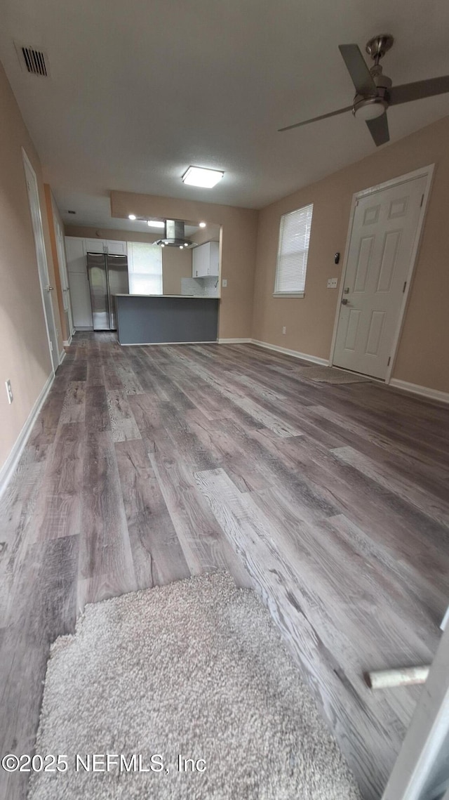 2756 Hidden Village Dr, Jacksonville, FL 32216 - unfurnished living room with ceiling fan, visible vents, baseboards, and wood finished floors