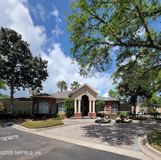 ranch-style home featuring stucco siding