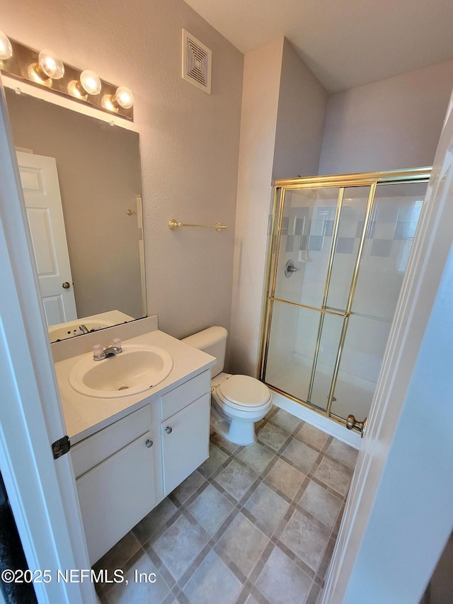 full bathroom with toilet, vanity, visible vents, and a stall shower