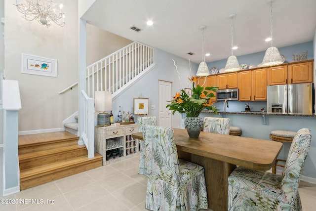 dining space featuring stairway, visible vents, baseboards, light tile patterned flooring, and recessed lighting