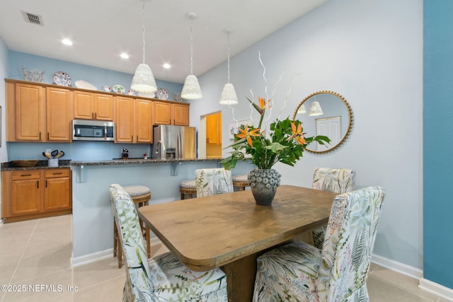 dining room with light tile patterned floors, visible vents, recessed lighting, and baseboards