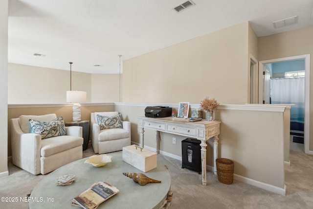 living area featuring carpet flooring, visible vents, and baseboards