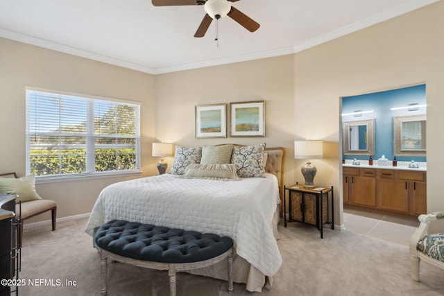 bedroom with baseboards, ornamental molding, light carpet, and ensuite bath
