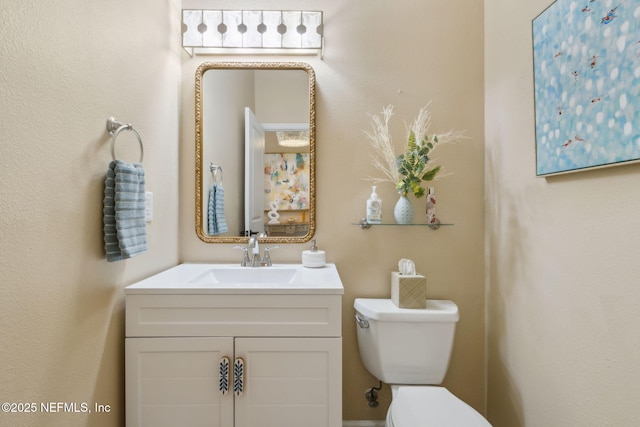 half bathroom featuring toilet and vanity