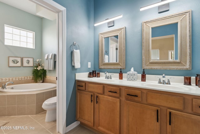 bathroom featuring tile patterned floors, double vanity, a bath, and a sink
