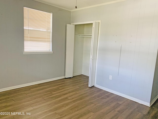 5133 Palmer Ave, Jacksonville, FL 32210 - unfurnished bedroom featuring crown molding, a closet, baseboards, and wood finished floors