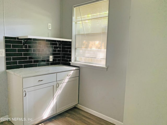 5133 Palmer Ave, Jacksonville, FL 32210 - kitchen with plenty of natural light, dark wood-style flooring, baseboards, and decorative backsplash
