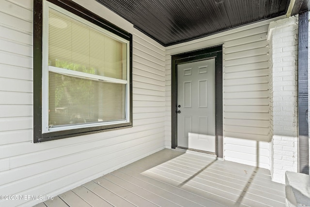 view of exterior entry featuring a porch