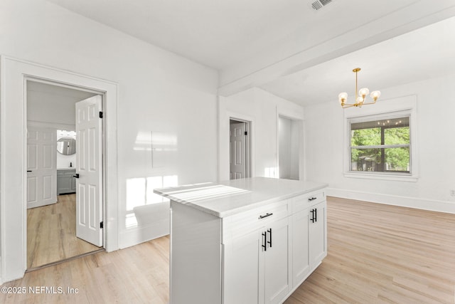 kitchen featuring decorative light fixtures, light wood-type flooring, an inviting chandelier, and white cabinets