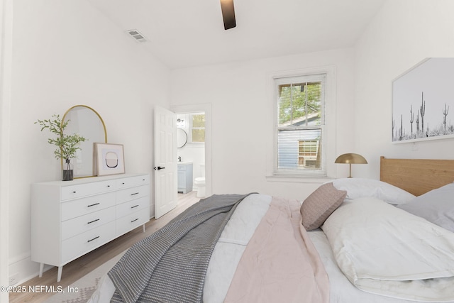 bedroom featuring visible vents, ceiling fan, connected bathroom, and wood finished floors