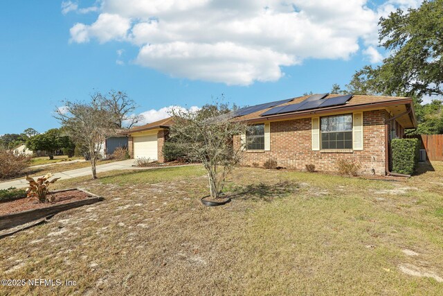 2566 Sandlewood Cir, Orange Park, FL 32065 - single story home featuring an attached garage, concrete driveway, a front lawn, and brick siding
