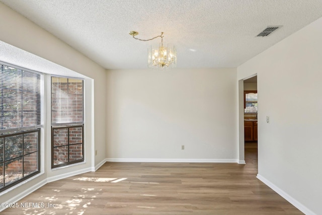 2566 Sandlewood Cir, Orange Park, FL 32065 - unfurnished dining area with visible vents, baseboards, a notable chandelier, and wood finished floors