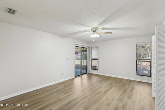 2566 Sandlewood Cir, Orange Park, FL 32065 - spare room featuring baseboards, a textured ceiling, visible vents, ceiling fan, and wood finished floors