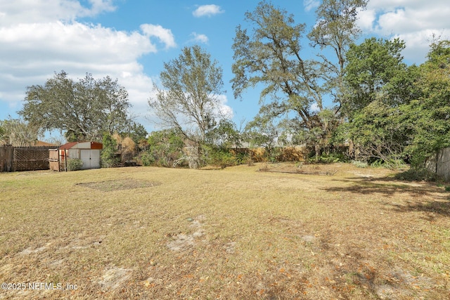 2566 Sandlewood Cir, Orange Park, FL 32065 - view of yard with a storage shed, an outdoor structure, and fence
