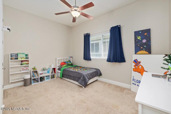 carpeted bedroom with baseboards and a ceiling fan