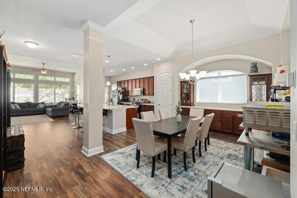 dining room with dark wood-style flooring, baseboards, recessed lighting, and ceiling fan with notable chandelier