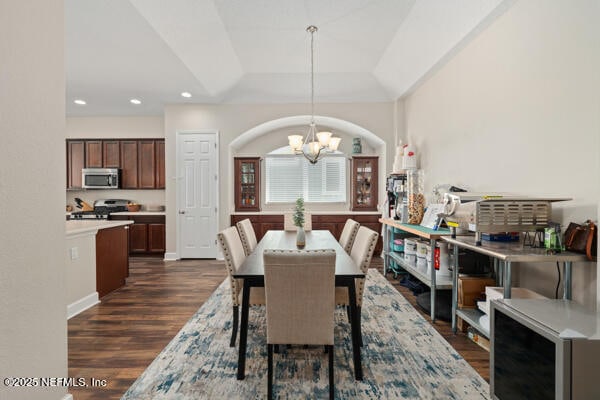 dining area with recessed lighting, a notable chandelier, and dark wood finished floors