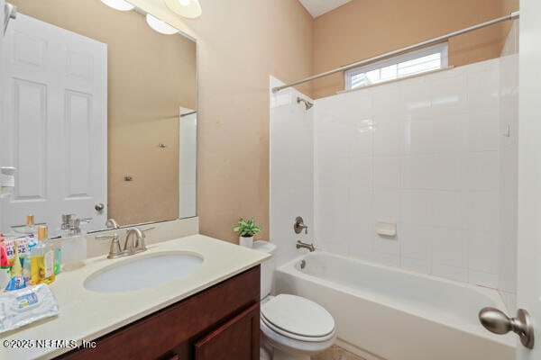 bathroom featuring toilet, shower / bath combination, and vanity