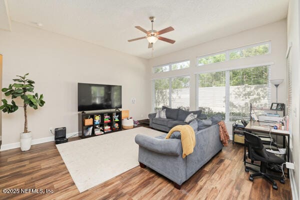 living room with wood finished floors, baseboards, and a ceiling fan