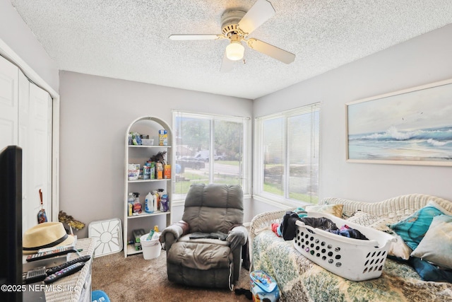 bedroom with a closet, a ceiling fan, carpet, and a textured ceiling