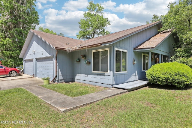 ranch-style house with driveway, a front lawn, a shingled roof, and a garage