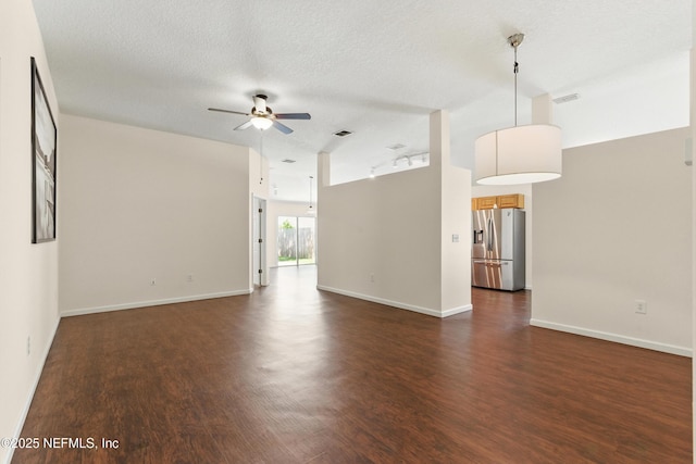 1217 Maclaren St, Saint Augustine, FL 32092 - unfurnished living room with a textured ceiling, ceiling fan, baseboards, and dark wood-style floors