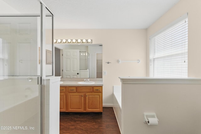1217 Maclaren St, Saint Augustine, FL 32092 - bathroom featuring a shower stall, vanity, a bath, and wood finished floors