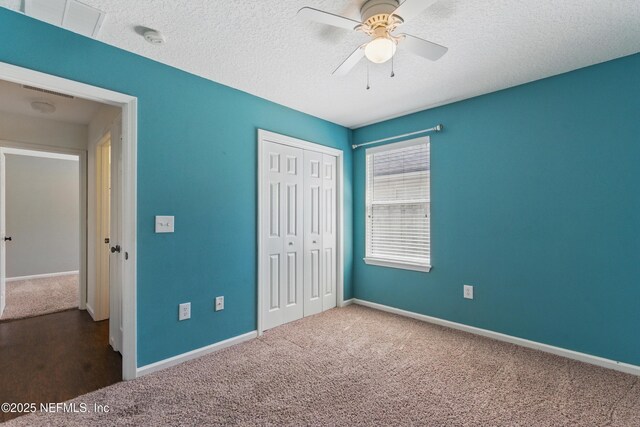 1217 Maclaren St, Saint Augustine, FL 32092 - unfurnished bedroom featuring a textured ceiling, a closet, a ceiling fan, carpet flooring, and baseboards
