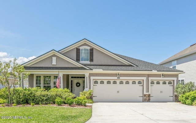 311 Wild Rose Dr, Saint Johns, FL 32259 - view of front facade with an attached garage, roof with shingles, driveway, and stucco siding