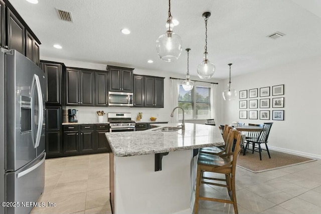 311 Wild Rose Dr, Saint Johns, FL 32259 - kitchen with light stone countertops, a sink, visible vents, and stainless steel appliances