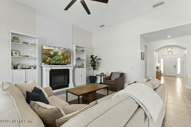 311 Wild Rose Dr, Saint Johns, FL 32259 - living room featuring arched walkways, visible vents, a ceiling fan, and light tile patterned flooring