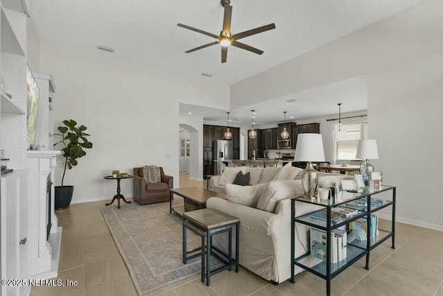 311 Wild Rose Dr, Saint Johns, FL 32259 - living area with arched walkways, light tile patterned floors, baseboards, and ceiling fan